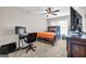 Bright bedroom featuring carpet, a ceiling fan, and a wooden-framed bed with orange accents at 803 Baugh Springs Ln, Lawrenceville, GA 30044