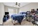 Bedroom with carpet, a ceiling fan, and a bed with blue and white striped bedding at 803 Baugh Springs Ln, Lawrenceville, GA 30044