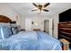 Bright bedroom with a ceiling fan, plush bed, and a dark wood dresser at 803 Baugh Springs Ln, Lawrenceville, GA 30044