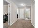 Hallway with neutral walls and carpet flooring with open doorways to rooms at 803 Baugh Springs Ln, Lawrenceville, GA 30044