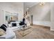 Open-concept living room with a high ceiling, white sofa, carpeted floor, and staircase at 803 Baugh Springs Ln, Lawrenceville, GA 30044