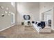 Bright and open living room with high ceilings, carpet flooring, and a modern white sofa at 803 Baugh Springs Ln, Lawrenceville, GA 30044