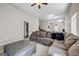 Expansive living room with plush sofa, ottoman, and ample natural light, perfect for relaxation at 803 Baugh Springs Ln, Lawrenceville, GA 30044