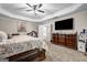 Comfortable main bedroom with tray ceilings, a ceiling fan, and plush carpeting at 803 Baugh Springs Ln, Lawrenceville, GA 30044