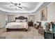 Relaxing main bedroom with a king-size bed, accent chairs, and cozy carpeting at 803 Baugh Springs Ln, Lawrenceville, GA 30044