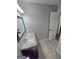 Bathroom featuring neutral paint, a modern vanity with quartz countertop, and wood-look tile flooring at 64 Shadow Ct, Palmetto, GA 30268