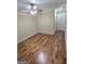 Bedroom featuring hardwood floors, a ceiling fan, and a door leading to a closet or en-suite bathroom at 64 Shadow Ct, Palmetto, GA 30268