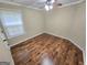Cozy bedroom features hardwood floors, a ceiling fan, and a window at 64 Shadow Ct, Palmetto, GA 30268