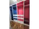 Custom walk-in closet with ample storage space, drawers and shelving, in a playful blue and pink color scheme at 64 Shadow Ct, Palmetto, GA 30268