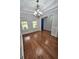 Hardwood flooring, decorative molding, and bright natural light in this dining area with a modern chandelier at 64 Shadow Ct, Palmetto, GA 30268