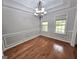 Dining room features hardwood floors, decorative molding, and a view of the green outdoors through dual windows at 64 Shadow Ct, Palmetto, GA 30268