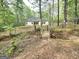 Charming house in wooded lot with a wooden bridge leading to the entrance, offering natural beauty and privacy at 64 Shadow Ct, Palmetto, GA 30268