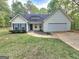 Charming single-Gathering home featuring a well-maintained lawn and two-car garage in a tree-lined neighborhood at 64 Shadow Ct, Palmetto, GA 30268