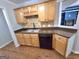 Kitchen features stainless sink, black dishwasher, and light brown cabinets at 64 Shadow Ct, Palmetto, GA 30268