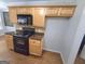The kitchen includes modern appliances and light brown cabinetry at 64 Shadow Ct, Palmetto, GA 30268