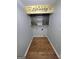 Small laundry room featuring wood floors and rustic sign at 64 Shadow Ct, Palmetto, GA 30268