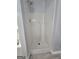 Bathroom featuring a white tiled shower with light gray walls at 64 Shadow Ct, Palmetto, GA 30268