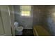 Bathroom features a toilet, tiled shower and tub area, as well as a window to provide light at 2450 Highway 155 N, Mcdonough, GA 30252