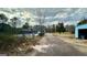Back exterior view featuring a brick home with a pool and wooded lot at 2450 Highway 155 N, Mcdonough, GA 30252