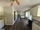 Open kitchen with modern appliances, cabinets, and laminate floors at 2450 Highway 155 N, Mcdonough, GA 30252