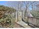 A rustic wooden gate provides access to the backyard of this property at 319 Corrigan Trce, Peachtree City, GA 30269