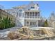 Shot of the backyard with the house showing a porch with a hot tub and rock landscaping at 319 Corrigan Trce, Peachtree City, GA 30269