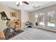 Basement exercise room with bike, free weights, and French doors to the outside at 319 Corrigan Trce, Peachtree City, GA 30269