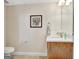 Elegant half bathroom featuring a marble countertop, stylish fixtures, and decorative wall art at 319 Corrigan Trce, Peachtree City, GA 30269
