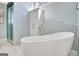 Bright bathroom showcasing a modern soaking tub, mosaic tile accent wall, and glass enclosed shower at 319 Corrigan Trce, Peachtree City, GA 30269