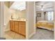 Bathroom view from bedroom, showcases a vanity with mirror and overhead lighting at 319 Corrigan Trce, Peachtree City, GA 30269