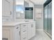 Bathroom vanity featuring white cabinets, drawers, and a white countertop, with a shower in the background at 319 Corrigan Trce, Peachtree City, GA 30269