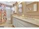 Bathroom featuring double vanity with stone counters, wall to wall mirror, and tub/shower combo at 319 Corrigan Trce, Peachtree City, GA 30269