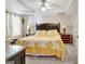 Bedroom features a ceiling fan, plush bed, side tables with lamps, and neutral-toned walls at 319 Corrigan Trce, Peachtree City, GA 30269