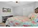 Bedroom featuring a floral quilt, a ceiling fan, and a large closet at 319 Corrigan Trce, Peachtree City, GA 30269