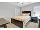 Bedroom features a dark wood bed frame with floral bedding, ceiling fan, and closet at 319 Corrigan Trce, Peachtree City, GA 30269