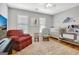 Bright Bedroom with a grey crib, changing table, and a comfy red chair at 319 Corrigan Trce, Peachtree City, GA 30269