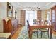 Formal dining room with a wooden table, stylish chairs, and a decorative cabinet, perfect for entertaining guests at 319 Corrigan Trce, Peachtree City, GA 30269