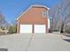Spacious two-car garage with white doors and a paved driveway at 319 Corrigan Trce, Peachtree City, GA 30269