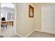 Hallway with a painting leading to a room with a bookshelf, desk, and chair at 319 Corrigan Trce, Peachtree City, GA 30269