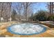 Outdoor hot tub with blue tile trim, set in a stone patio with surrounding landscaping at 319 Corrigan Trce, Peachtree City, GA 30269