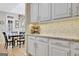 Kitchen cabinets with granite countertops, decorative backsplash, and wine rack offer ample storage and style at 319 Corrigan Trce, Peachtree City, GA 30269