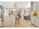 Bright, open kitchen with island seating, stainless steel appliances, and hardwood floors into the adjacent dining area at 319 Corrigan Trce, Peachtree City, GA 30269