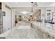Granite kitchen island with sink and faucet overlooking a living space with built-in shelving and decor at 319 Corrigan Trce, Peachtree City, GA 30269