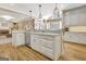Bright white kitchen island boasts stainless steel dishwasher and granite countertops with hardwood floors at 319 Corrigan Trce, Peachtree City, GA 30269