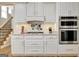 Stylish kitchen with stainless steel double ovens, and subway tile backsplash at 319 Corrigan Trce, Peachtree City, GA 30269