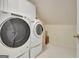 Bright laundry room with white washer and dryer units and linoleum flooring at 319 Corrigan Trce, Peachtree City, GA 30269