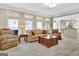 Spacious living room featuring large windows and comfortable seating arrangements at 319 Corrigan Trce, Peachtree City, GA 30269