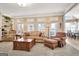 Bright living room with multiple windows, comfortable seating, and an open layout, perfect for relaxation and entertaining at 319 Corrigan Trce, Peachtree City, GA 30269