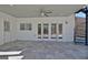 Covered patio with white siding, spiral staircase, and exterior access doors at 319 Corrigan Trce, Peachtree City, GA 30269
