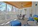 Relaxing screened porch with wood ceiling, ceiling fan, and comfortable blue seating at 319 Corrigan Trce, Peachtree City, GA 30269